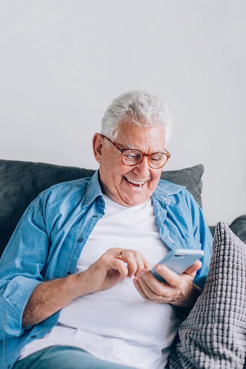 A member relaxed on the sofa, taking a call
