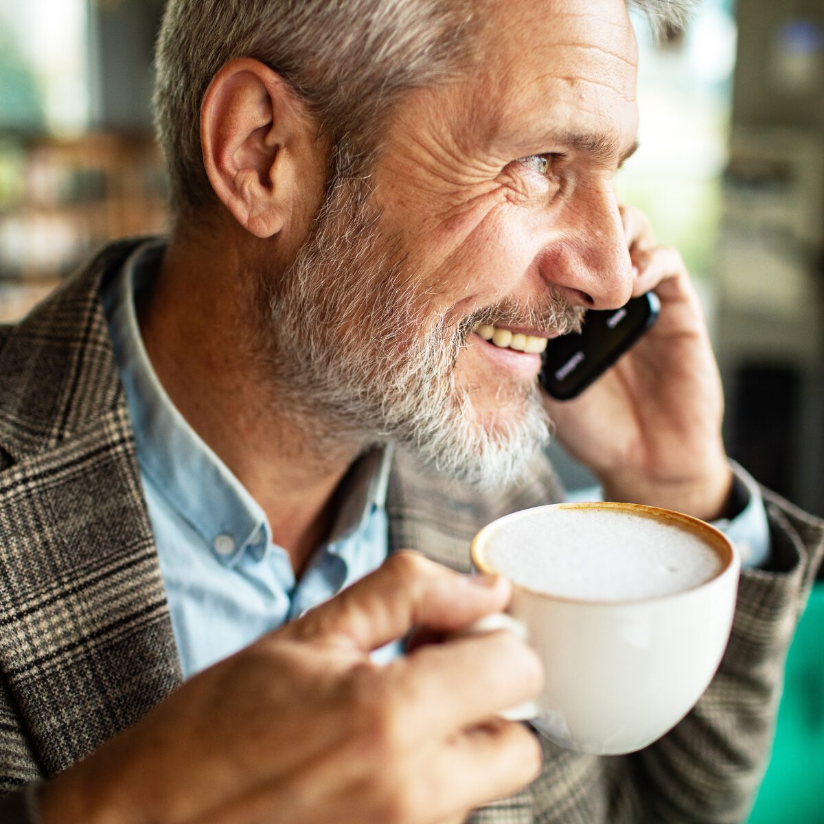 A relaxed member smiling at their phone at home