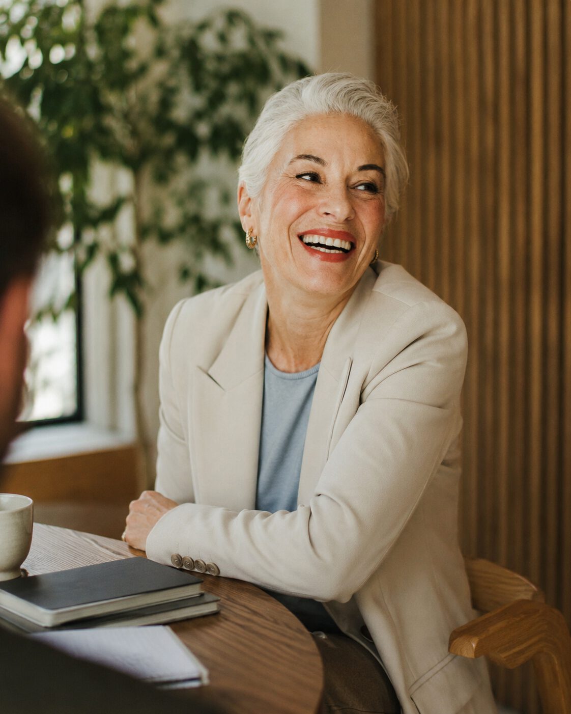 A relaxed leader smiling during a one-to-one conversation